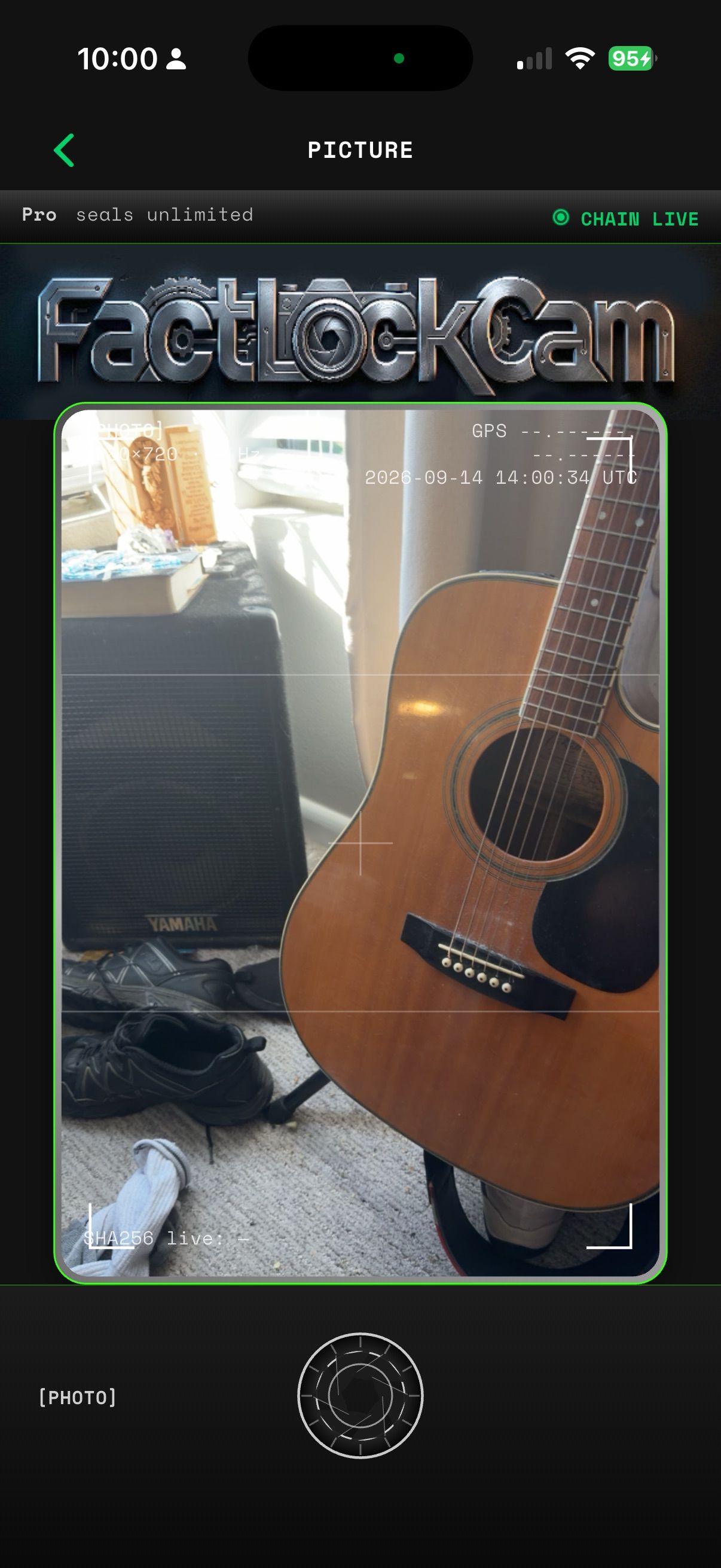 FactLockCam viewfinder on iPhone: live HUD with device clock, optional GPS, and the CHAIN LIVE lamp above the mechanical shutter